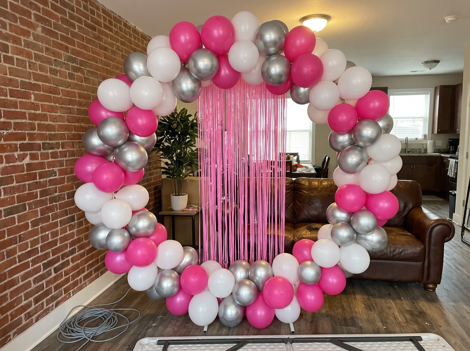 Round balloon arch in hot pink, white and chrome silver for a bachelorette weekend